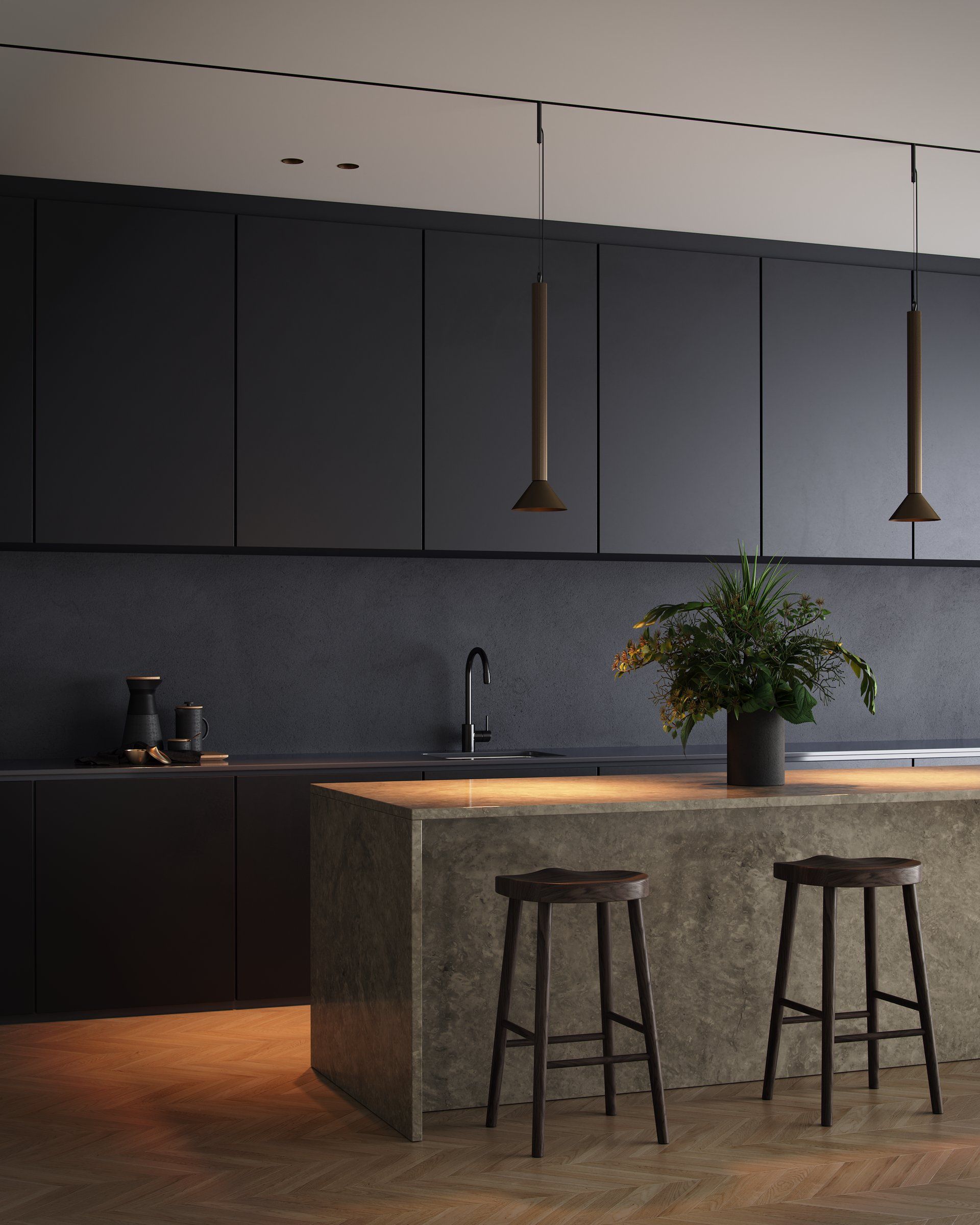 Donkere keuken met een natuurstenen eiland en twee slanke hanglampen aan een plafondrail
